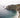 Rocky coastline with cliffs and turquoise waves under an overcast sky